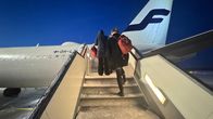 Passengers climbing up to an airplane.