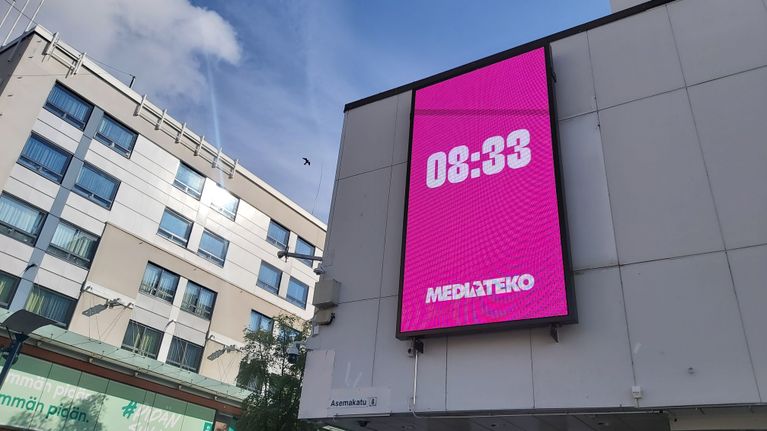 Kellonaika isolla valomainosnäytöllä Jyväskylän keskustassa.