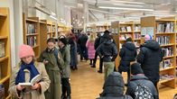 Vallilan kirjastossa ennakkoäänestyksessä jonottavia ihmisiä. Jonot kiertelevät kirjahyllyjen välissä.