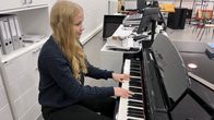 Kuvassa on Annika Haikka, joka soittaa pianoa. 