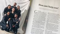 An open magazine, featuring a photo of several smiling people wearing black uniforms, with text on the opposite page.