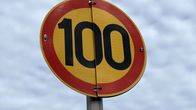 A speed traffic sign showing the number 100.