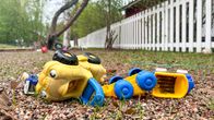 Plastic toy cars in an otherwise empty daycare centre yard.