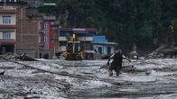 Photo shows a man trying to escape the flood waters.
