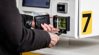 Person putting a credit card into a fuel automat.
