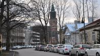 Bild av Biskopsgatan med bilar parkerade längs vägen och domkyrkan som tornar upp sig längst bort.
