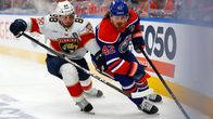 Nate Schmidt and Kasperi Kapanen fight for the puck.