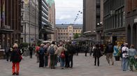 Photo shows people on a street in Helsinki.