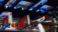 Closeup photo of a data server computer with coloured lights and wires.