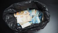 Euro notes in a plastic bag.