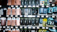 Store display with dozens of small electronic items in boxes.