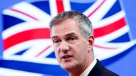 Peter Kyle kuvattuna Iso-Britannian lippu takanaan.