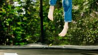 Legs jumping on a trampoline.
