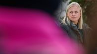 Talvitakki päällään seisova Elina Valtonen katsoo kamerasta sivuun.