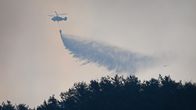 Helikopteri pudottaa vettä.