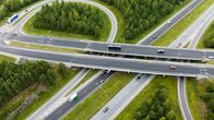 Aerial shot of a freeway and a cross-level interchange running across it.