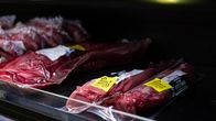 Meat products marked with yellow security tags.