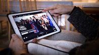 Henkilö selaa Netflixin tarjontaa iPadiltä.