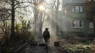 Photo shows a Ukrainian serviceman walking in the courtyard of damaged residential buildings in the frontline town of Kostyantynivka, Donetsk region.