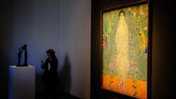 Gustav Klimtin maalaama keltasävyinen taulu Sotheby'sin huutokauppakamarin seinällä.