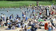 People enjoying a sunny day on a beach in Espoo.