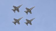 Four fighter jets fly in the air.