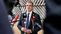 Petteri Orpo speaking behind four microphones.