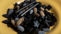 Different types of salmiakki candies in a bowl.