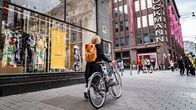 nainen taluttaa polkupyörää Aleksanterinkadulla Stockmannin edessä