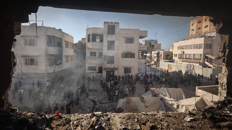 Palestinians in Gaza City view the damage to a house that was hit by an Israeli strike in September 2026.