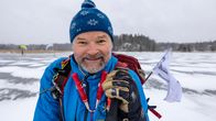 En man, Tuomas Hannikainen, tittar mot kameran på skridskobanan iförd full långfärdsskridskoutrustning.