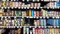Yogurts on supermarket shelves. 