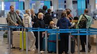 People standing in line at Helsinki Airport.