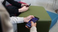 Photo shows two children holding phones in their hands.