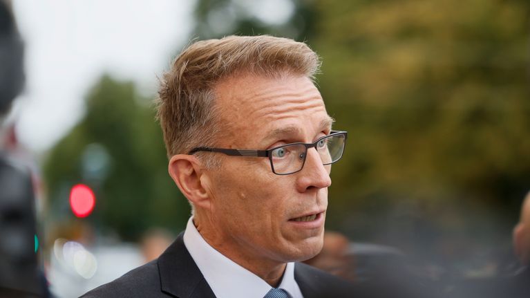 Jukka Kopra puku päällä puhuu median edessä ulkona.