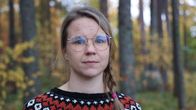 Lähikuva Camilla Nissisestä metsän keskellä.