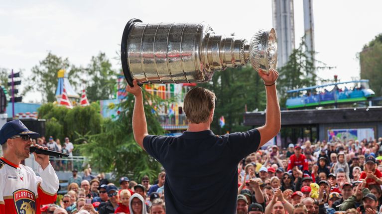 Jääkiekkoilija Anton Lundell kantaa Stanley Cup -pokaalia fanien ympäröimänä. Lavalla on myös JVG-yhtye.