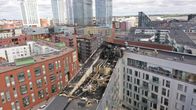 Aerial view of an urban area, with the roof of one building badly damaged by fire.