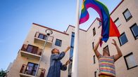Rainbow flag being lifted up to flagpole