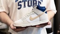 The Beyond Store X Nike SB Dunk Hi sneaker in hands.