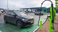 Photo shows an electric car at a charging station.