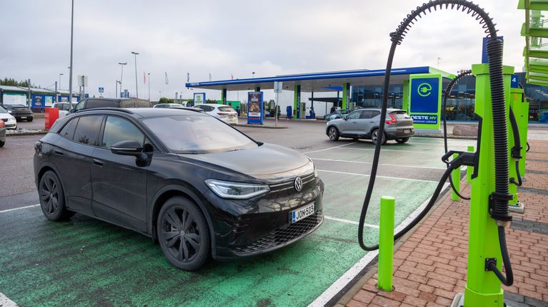 Photo shows an electric car at a charging station.