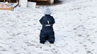 Photo shows a child in the yard of a daycare centre.