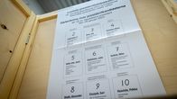 A list of the presidential candidates posted in a voting booth. 