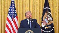 Donald Trump seisoo puhujakorokkeen takana ja pitää puhettaan Yhdysvaltain lippujen edessä Valkoisessa talossa 16. heinäkuuta 2026.
