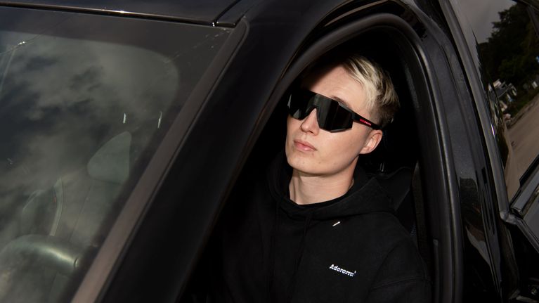 Isac Elliot istuu autossa.