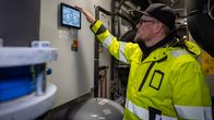 Qheatin teknologiajohtaja Rami Niemen tutkii lämmönjakohuoneen säätötaulua.