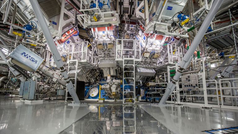Scaffolding and equipment surrounding a fusion reactor. 