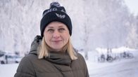 A blonde woman smiling against an Arctic backdrop. 