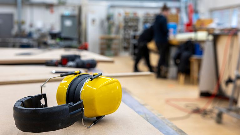 A pair of protective headphones on a workbench. 